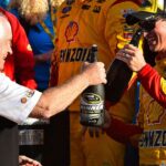 NASCAR Sprint Cup Series driver Joey Logano (22) celebrates with team owner Roger Penske in victory lane after winning the Daytona 500 at Daytona International Speedway.