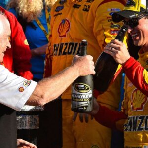 NASCAR Sprint Cup Series driver Joey Logano (22) celebrates with team owner Roger Penske in victory lane after winning the Daytona 500 at Daytona International Speedway.