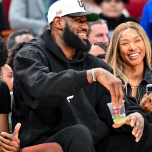 Los Angeles Laker LeBron James and his wife Savannah James sit court side at the McDonald's All American game during the first half at Toyota Center.