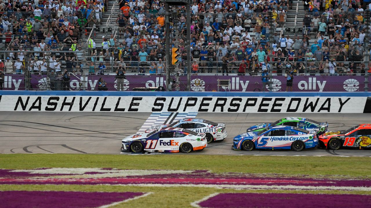 NASCAR Cup Series driver Ross Chastain (1), Denny Hamlin (11), Kyle Busch (8), and Kyle Larson (5) come to the line after a restart during the Ally 400 at Nashville Superspeedway.