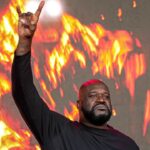 Shaquille O'Neal holds up the sign of the horns during a DJ performance ahead of the College Football Playoff semifinal game between the Texas Longhorns and Ohio State in the Cotton Bowl at AT&T Stadium on Friday, Jan. 10, 2024 in Arlington, Texas.