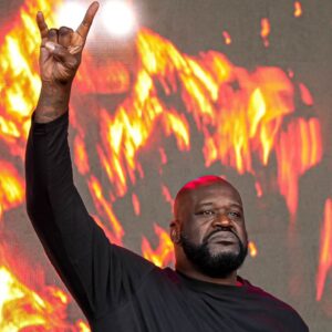 Shaquille O'Neal holds up the sign of the horns during a DJ performance ahead of the College Football Playoff semifinal game between the Texas Longhorns and Ohio State in the Cotton Bowl at AT&T Stadium on Friday, Jan. 10, 2024 in Arlington, Texas.
