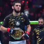 Islam Makhachev (red gloves) reacts after defeating Renato Moicano (not pictured) in a lightweight title fight during UFC 311 at Intuit Dome.