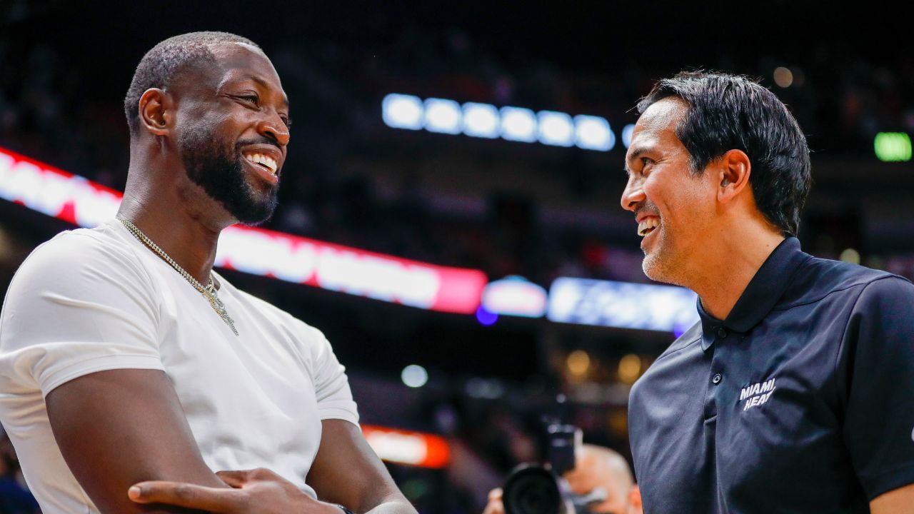 Former Miami Heat player Dwyane Wade talks to Miami Heat head coach Erik Spoelstra after the game against the Washington Wizards at FTX Arena
