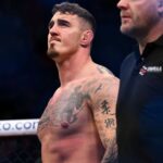 om Aspinall (red gloves) reacts to defeating Marcin Tybura (blue gloves) during UFC Fight Night at O2 Arena