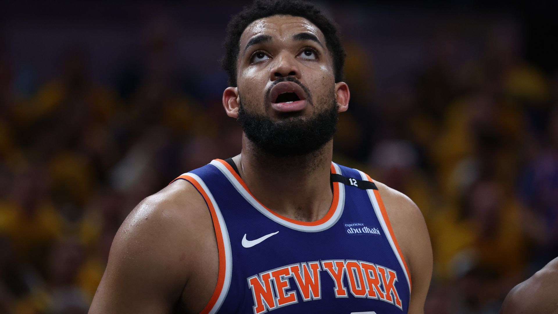 May 27, 2025; Indianapolis, Indiana, USA; New York Knicks center Karl-Anthony Towns (32) looks up at a scoreboard during the third quarter against the Indiana Pacers of game four of the eastern conference finals for the 2025 NBA Playoffs at Gainbridge Fieldhouse