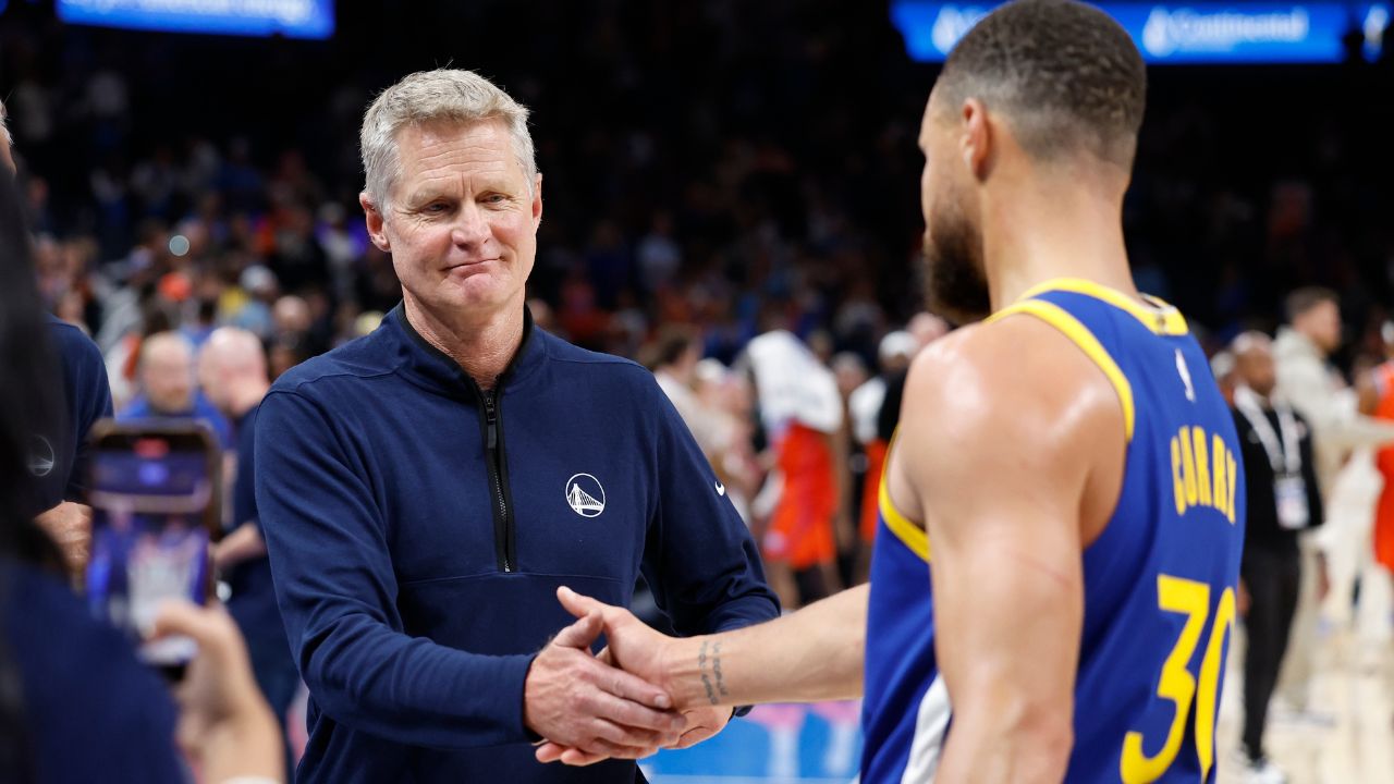 Golden State Warriors head coach Steve Kerr celebrates with guard Stephen Curry (30) after their team defeated the Oklahoma City Thunder at Paycom Center.