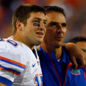 Florida Gators head coach Urban Meyer and quarterback Tim Tebow (15) hug each other against the Georgia Bulldogs against the Georgia Bulldogsduring the second half at Jacksonville Municipal Stadium. Gators won 49- 10.