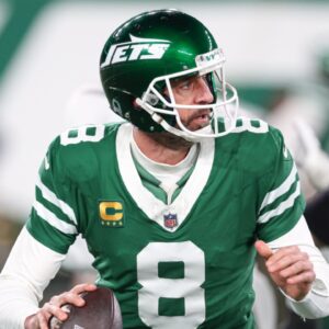New York Jets quarterback Aaron Rodgers (8) rolls out during the first half against the Miami Dolphins at MetLife Stadium.