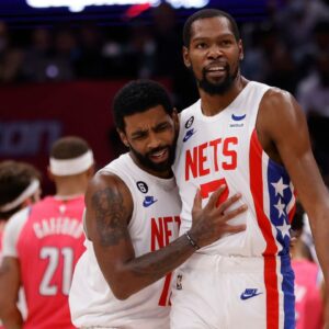 Brooklyn Nets guard Kyrie Irving (11) celebrates with Nets forward Kevin Durant (7) against the Washington Wizards in the fourth quarter at Capital One Arena.