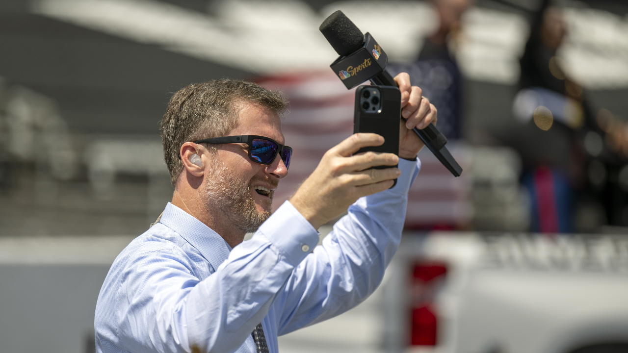 Dale Earnhardt Jr. raises his hands to cheering fans on the grid before the Verizon 200 at the Indianapolis Motor Speedway Road Course.