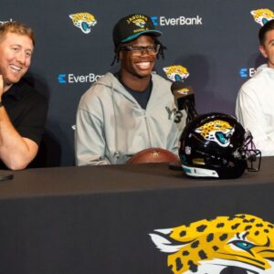 Jacksonville Jaguars ead Coach Liam Coen, left, has a laugh with Jacksonville Jaguars’ first-round pick, Colorado Buffaloes wide receiver and defensive back Travis Hunter, center, during a press conference Friday, March 25, 2025 at Miller Electric Center in Jacksonville, Fla. with General Manager James Gladstone, right