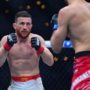 Merab Dvalishvili (red gloves) fights Umar Nurmagomedov (blue gloves) during UFC 311 at Intuit Dome.