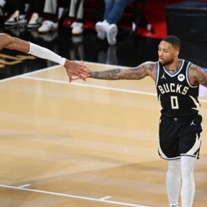 Dec 14, 2024; Las Vegas, Nevada, USA; Milwaukee Bucks guard Damian Lillard (0) and forward Giannis Antetokounmpo (34) react during the fourth quarter against the Atlanta Hawks in a semifinal of the 2024 Emirates NBA Cup at T-Mobile Arena. Mandatory Credit: Candice Ward-Imagn Images