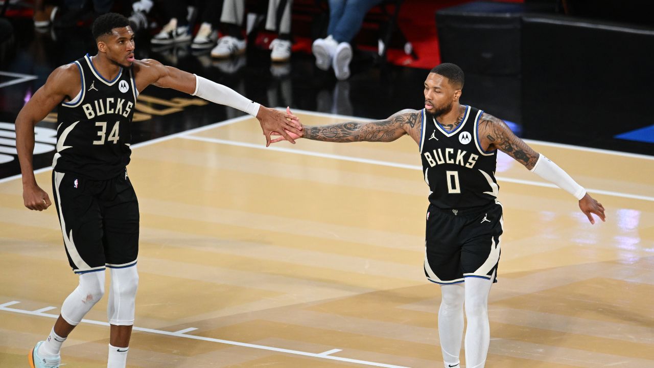 Dec 14, 2024; Las Vegas, Nevada, USA; Milwaukee Bucks guard Damian Lillard (0) and forward Giannis Antetokounmpo (34) react during the fourth quarter against the Atlanta Hawks in a semifinal of the 2024 Emirates NBA Cup at T-Mobile Arena. Mandatory Credit: Candice Ward-Imagn Images