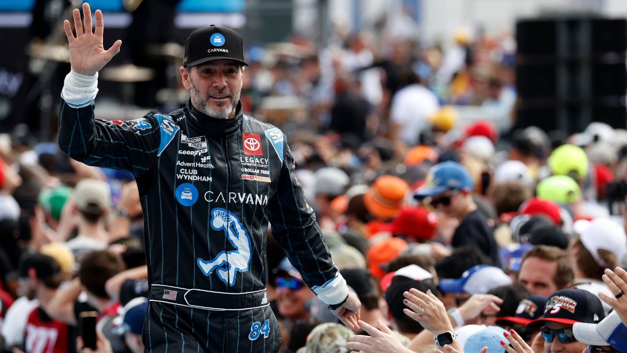 Former NASCAR Cup Series driver Jimmie Johnson (84) walks onto the driver introduction stage to greet fans before the Daytona 500 at Daytona International Speedway.