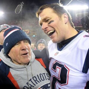 New England Patriots head coach Bill Belichick and quarterback Tom Brady (12) celebrate the win over the Kansas City Chiefs during overtime in the AFC Championship game at Arrowhead Stadium.