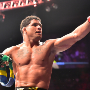Gilbert Burns (red gloves) reacts after the fight against Neil Magny (blue gloves) during UFC 283