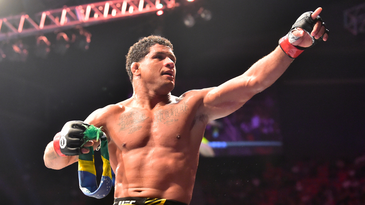 Gilbert Burns (red gloves) reacts after the fight against Neil Magny (blue gloves) during UFC 283