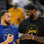 Golden State Warriors guard Stephen Curry (left) and Los Angeles Lakers forward LeBron James (right) talk before the game at Chase Center.