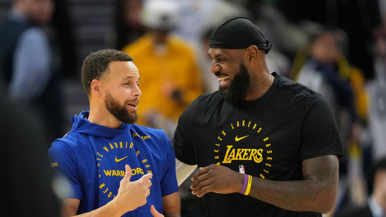Golden State Warriors guard Stephen Curry (left) and Los Angeles Lakers forward LeBron James (right) talk before the game at Chase Center.