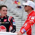 NASCAR Cup Series driver Christopher Bell (20) and NASCAR Cup Series driver Denny Hamlin (11) ride to pit road before the start of the Quaker State 400 at Atlanta Motor Speedway.