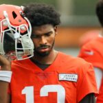 Cleveland Browns quarterback Shedeur Sanders (12) listens to the play calling on the sideline during an NFL practice at the Cleveland Browns training facility on Wednesday, May 28, 2025, in Berea, Ohio.