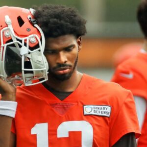 Cleveland Browns quarterback Shedeur Sanders (12) listens to the play calling on the sideline during an NFL practice at the Cleveland Browns training facility on Wednesday, May 28, 2025, in Berea, Ohio.