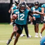 Jacksonville Jaguars wide receiver Travis Hunter (12) participates in a drill during rookie minicamp at Miller Electric Center.