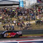 Fans watch Red Bull Chevrolet driver Connor Zilisch (87) round turn 18 during the NASCAR Cup Series EchoPark Automotive Grand Prix at Circuit of the Americas on Sunday, March 2, 2025 in Austin.