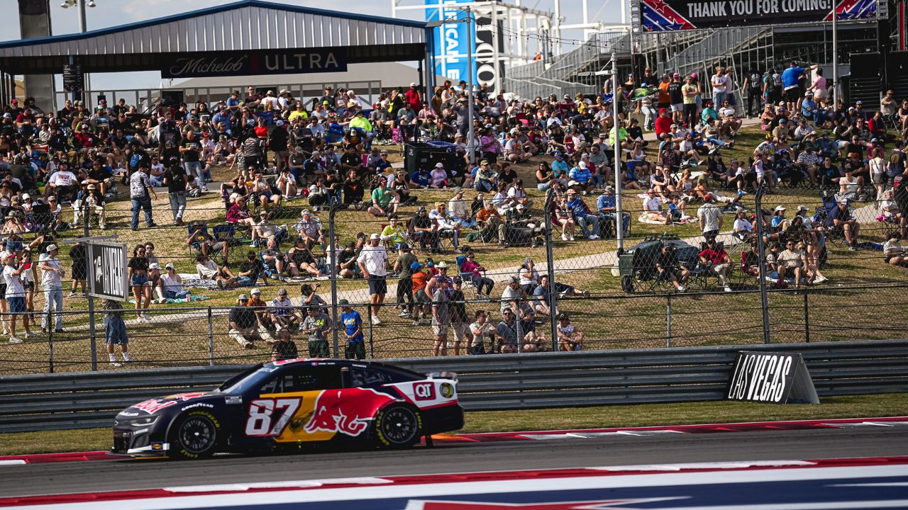 Fans watch Red Bull Chevrolet driver Connor Zilisch (87) round turn 18 during the NASCAR Cup Series EchoPark Automotive Grand Prix at Circuit of the Americas on Sunday, March 2, 2025 in Austin.