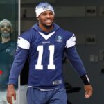 Cowboys defensive end Micah Parsons (11) walks onto the practice field at the Ford Center at the Star Training Facility in Frisco, Texas.