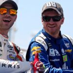 Dale Earnhardt Jr. talks with NASCAR Cup Series driver Daniel Suarez (19) before the Toyota Owners 400 at Richmond International Raceway.