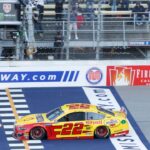 Monster Energy NASCAR Cup Series driver Joey Logano (22) takes the checkered flag for the win during the FireKeepers Casino 400 at Michigan International Speedway.
