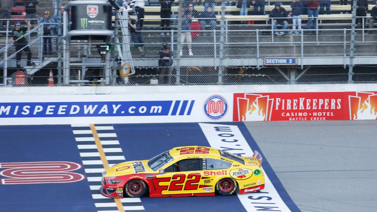 Monster Energy NASCAR Cup Series driver Joey Logano (22) takes the checkered flag for the win during the FireKeepers Casino 400 at Michigan International Speedway.