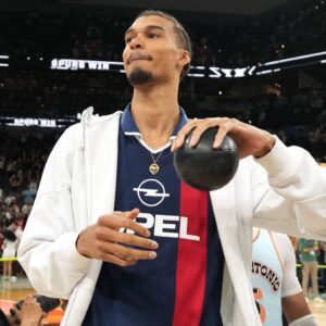 San Antonio Spurs center Victor Wembanyama (1) prepares to throw a ball in to the stands in celebration of Fan Appreciation Day after a victory over the Toronto Raptors at Frost Bank Center.