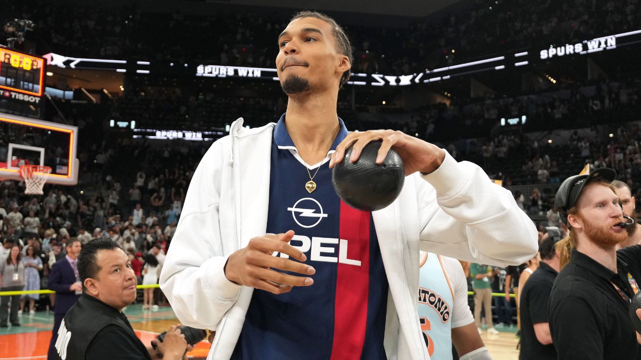 San Antonio Spurs center Victor Wembanyama (1) prepares to throw a ball in to the stands in celebration of Fan Appreciation Day after a victory over the Toronto Raptors at Frost Bank Center.