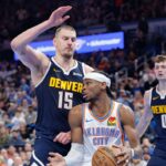 Mar 10, 2025; Oklahoma City, Oklahoma, USA; Denver Nuggets center Nikola Jokic (15) defends a drive by Oklahoma City Thunder guard Shai Gilgeous-Alexander (2) during the second half at Paycom Center. Mandatory Credit: Alonzo Adams-Imagn Images