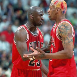Chicago Bulls forward #91 DENNIS RODMAN is held back from the official by guard #23 MICHAEL JORDAN against the Miami Heat at the Miami Arena during the 1996-97 season.