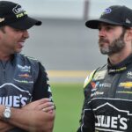 NASCAR Cup Series crew chief Chad Knaus (L) talks to his driver Jimmie Johnson (R) prior to the Coke Zero Sugar 400 at Daytona International Speedway.