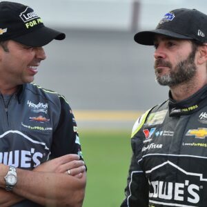 NASCAR Cup Series crew chief Chad Knaus (L) talks to his driver Jimmie Johnson (R) prior to the Coke Zero Sugar 400 at Daytona International Speedway.