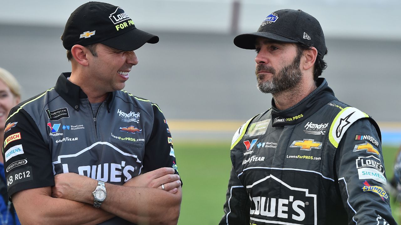 NASCAR Cup Series crew chief Chad Knaus (L) talks to his driver Jimmie Johnson (R) prior to the Coke Zero Sugar 400 at Daytona International Speedway.