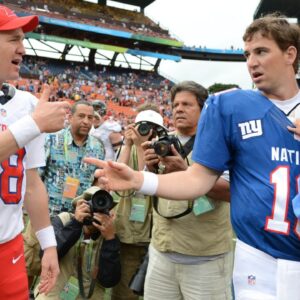 AFC quarterback Peyton Manning of the Denver Broncos (18, left) shakes hands with NFC quarterback Eli Manning of the New York Giants (10, right) after the 2013 Pro Bowl at Aloha Stadium. The NFC defeated the AFC 62-35.