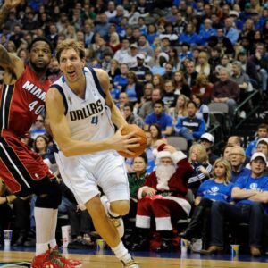 Dallas Mavericks power forward Dirk Nowitzki (41) drives past Miami Heat power forward Udonis Haslem (40) during the second quarter at the American Airlines Center