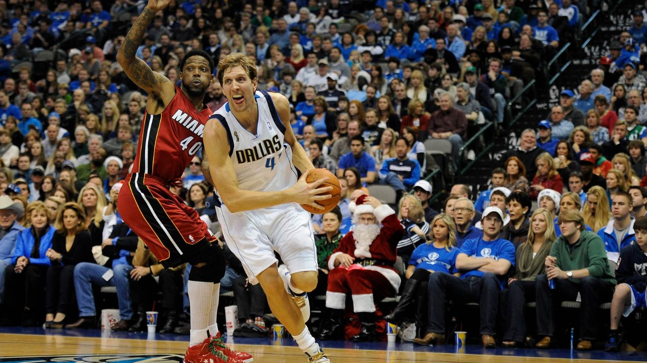 Dallas Mavericks power forward Dirk Nowitzki (41) drives past Miami Heat power forward Udonis Haslem (40) during the second quarter at the American Airlines Center