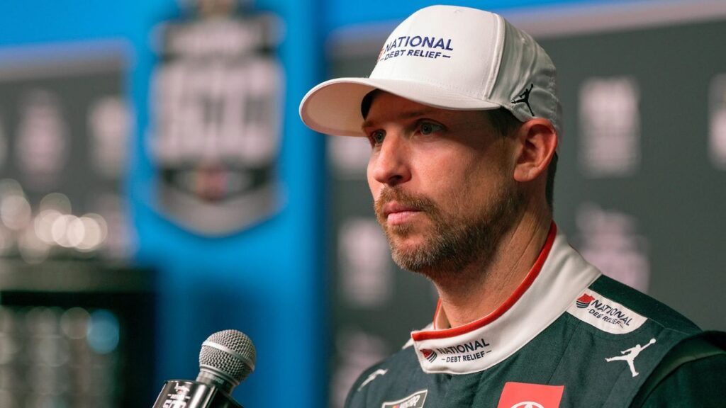 Denny Hamlin answers questions from reporters during Media Day at Daytona International Speedway, Wednesday, Feb. 12, 2025.