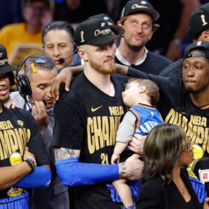 Isaiah Hartenstein celebrates championship while holding his son