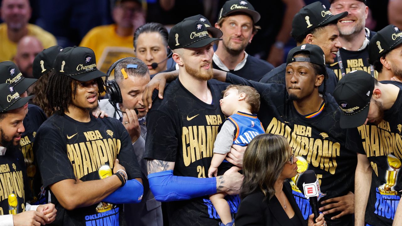 Isaiah Hartenstein celebrates championship while holding his son