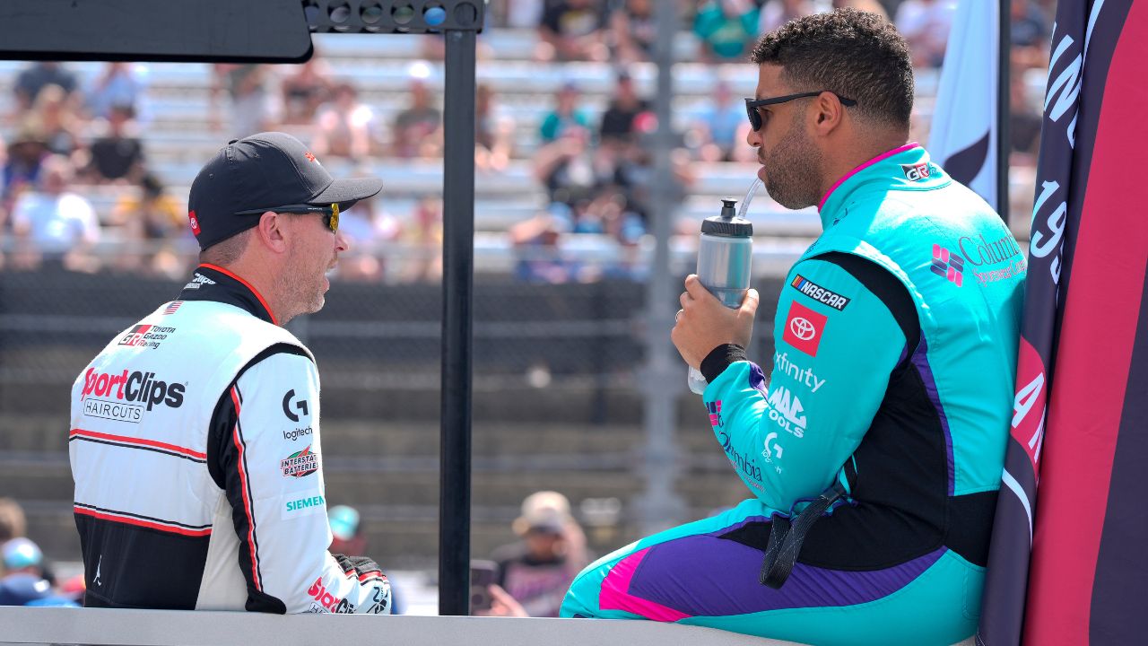 NASCAR Cup Series driver Denny Hamlin (11) chats with driver Bubba Wallace (23) during pre race intros during the Goodyear 400 at Darlington Raceway.
