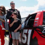 NASCAR Craftsman Truck Series driver Kyle Busch stands with his wife Samantha Busch and children Brexton and Lennix prior to the CRC Brakleen 150 at Pocono Raceway.